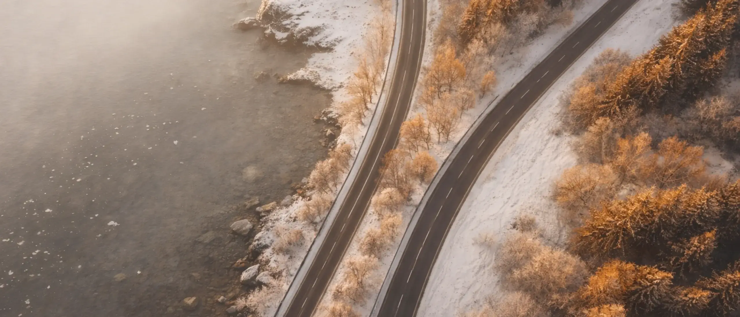 Ariel view of a road over a lake in muted tones