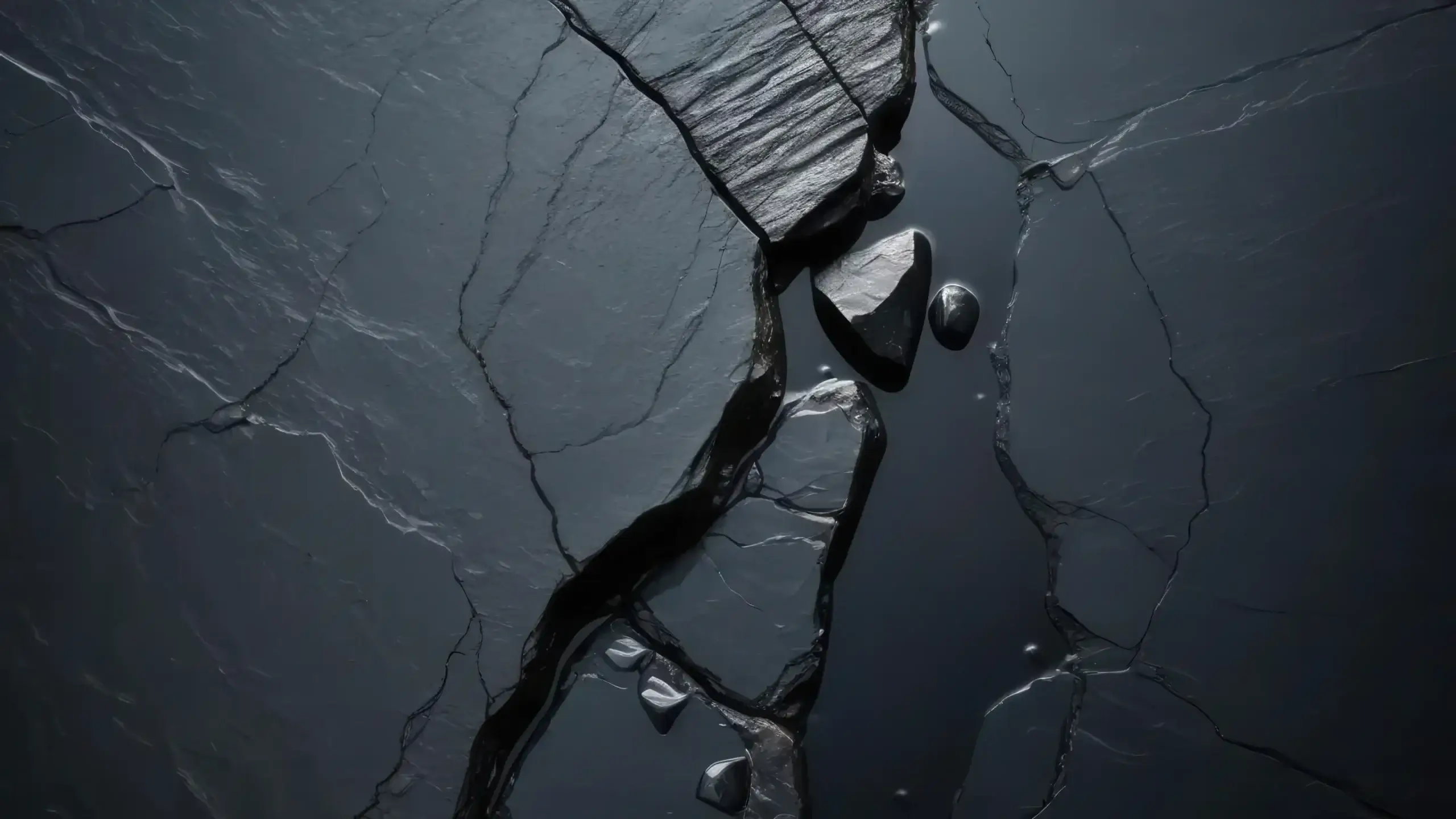 Abstract dark image of fractured stone or ice with a deep crack running through the centre, symbolising hidden structural weakness, risk, and resilience. Used to represent cybersecurity resilience, risk exposure, and the importance of strong security foundations in complex enterprise environments.