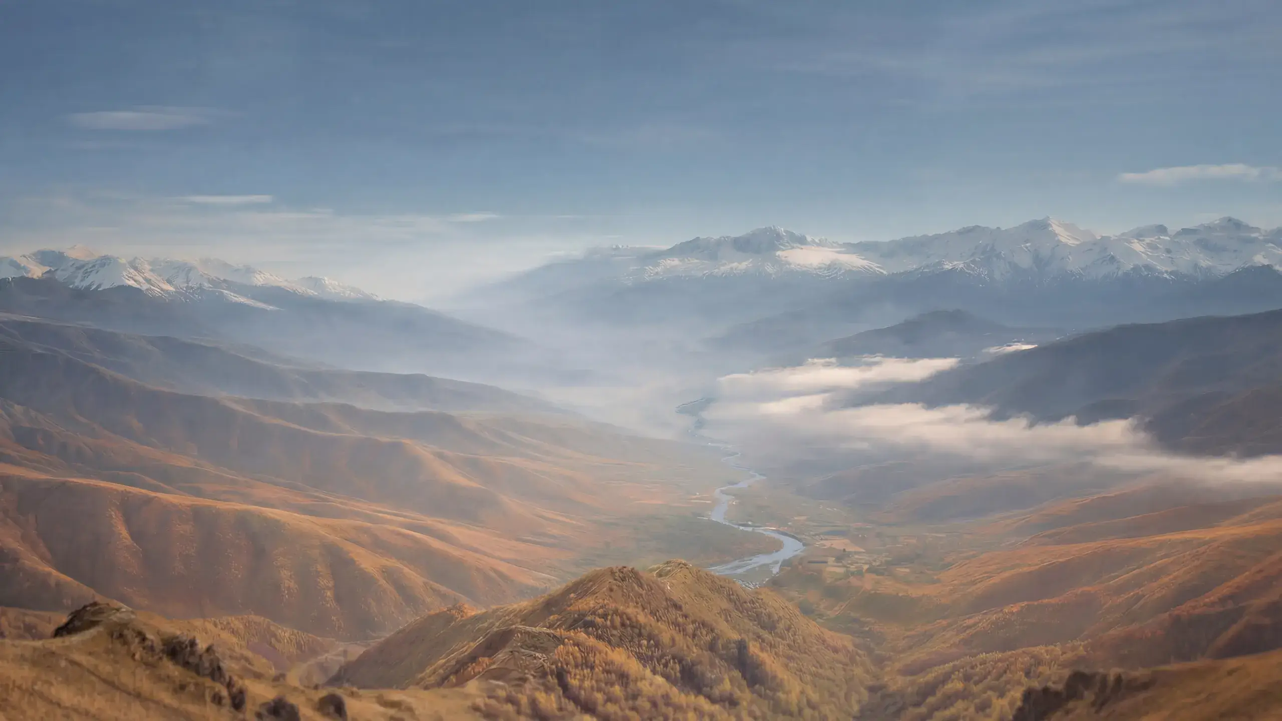 Wide aerial view of a river running through a mountain valley, used on the Protirus website to reflect the progression and direction of a cybersecurity career.